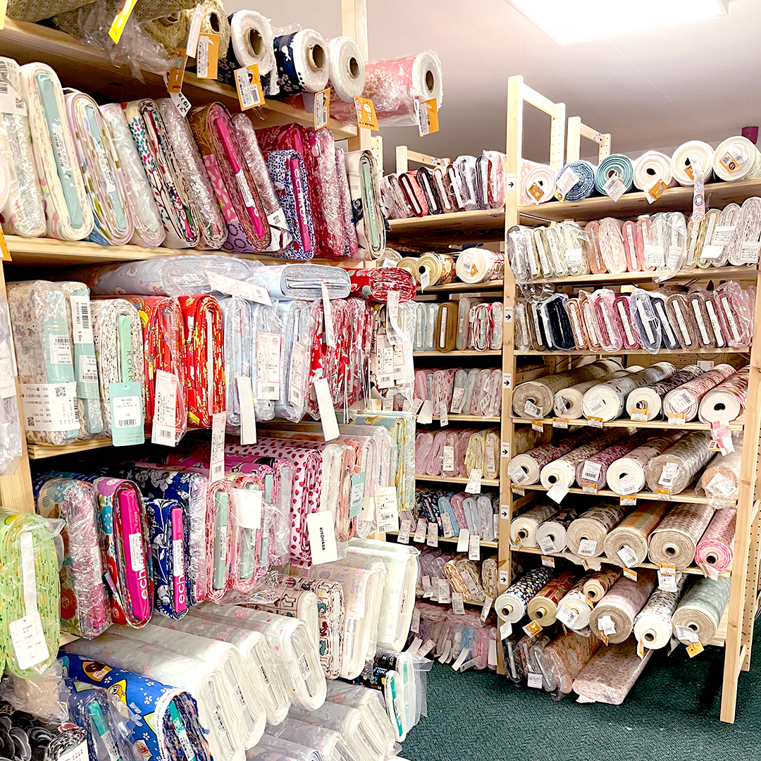 Shelves of fabric in the modes4u warehouse